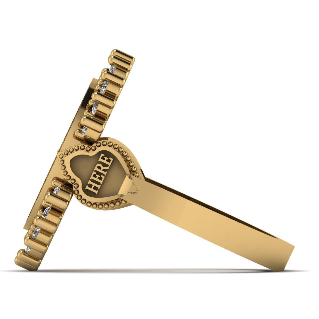 Gold decorative item with 'HERE' engraved on a white background